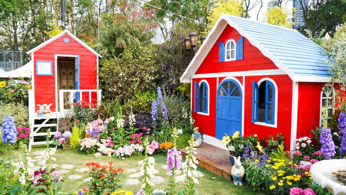 red and blue wooden house near green trees