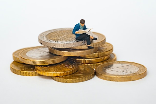 little person sitting on coins