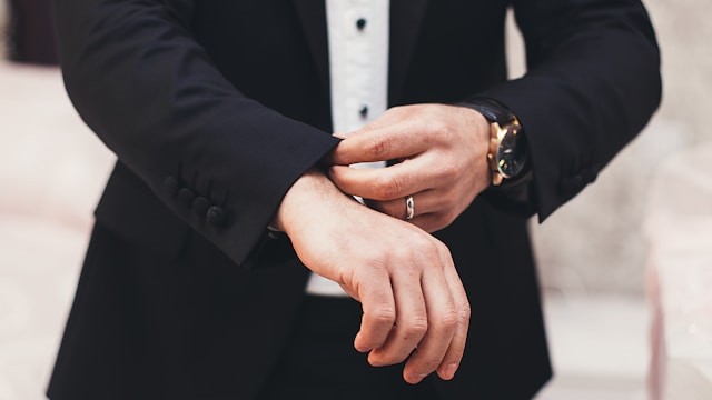 a-mans-hands-adjusting-the-cuffs-of-his-black-suit