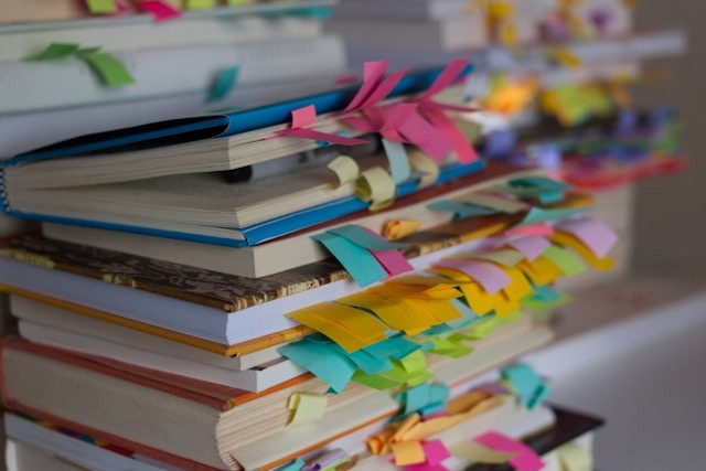 a-stack-of-books-with-colorful-ribbons-on-them