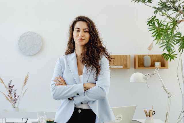 woman-in-sky-blue-blazer-standing-near-white-wall