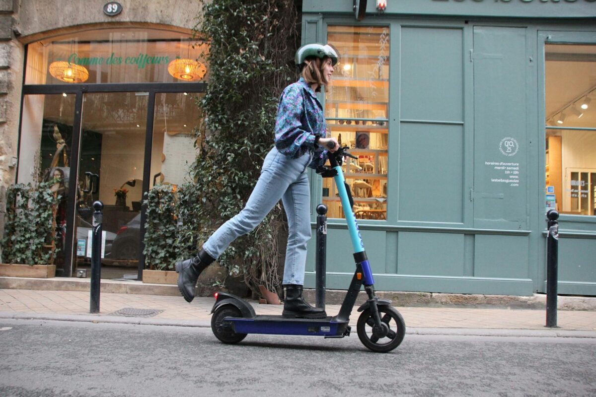 a-person-riding-a-scooter-on-a-city-street